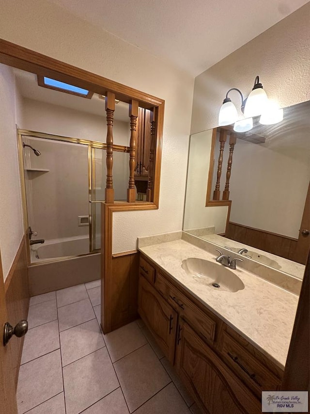 bathroom with tile patterned floors, shower / bath combination, and vanity