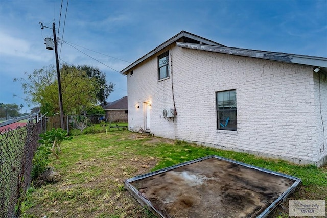 view of side of home featuring a yard