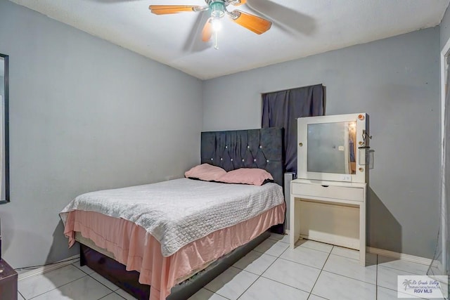 bedroom with ceiling fan and light tile patterned flooring