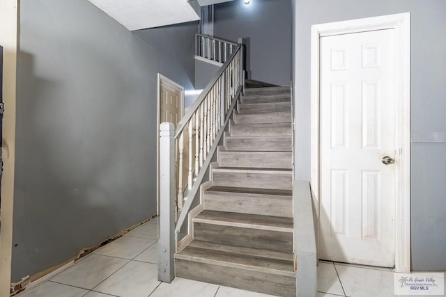 stairway featuring tile patterned floors