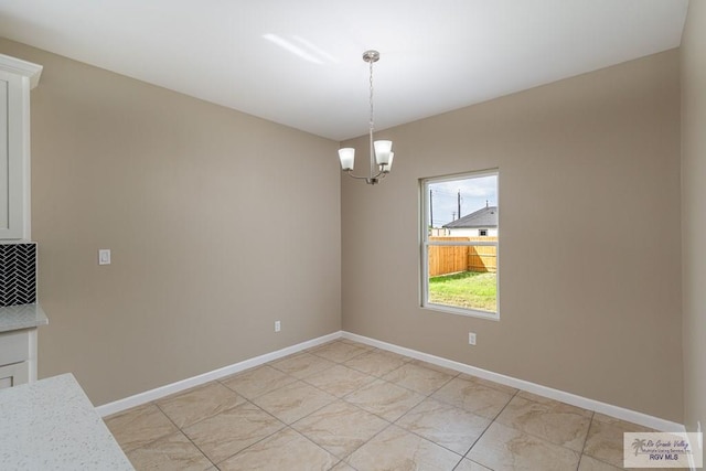 unfurnished dining area with a notable chandelier