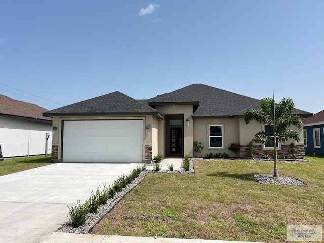 prairie-style home featuring a front yard and a garage