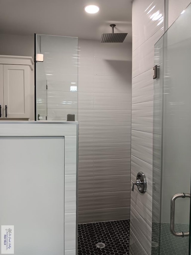 bathroom with a shower with shower door