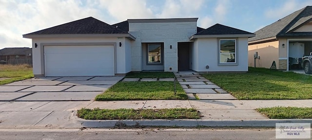 view of front of house with a garage and a front lawn