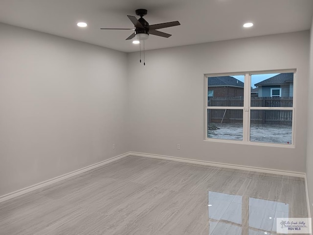 spare room featuring ceiling fan and light hardwood / wood-style flooring