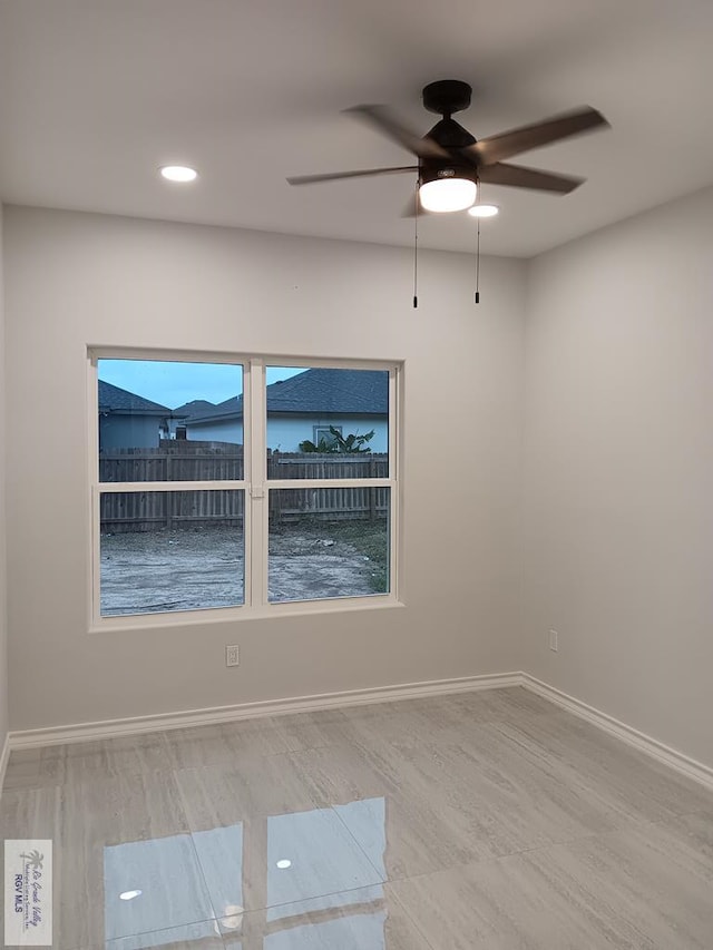 spare room featuring ceiling fan and hardwood / wood-style floors