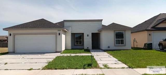 view of front of house featuring a garage and a front lawn