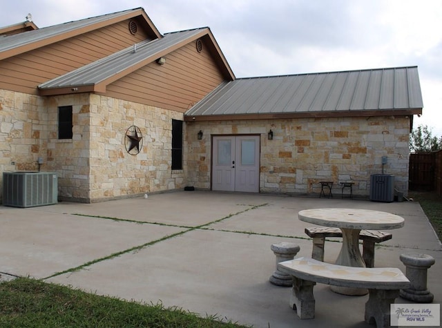 rear view of property featuring cooling unit and a patio area