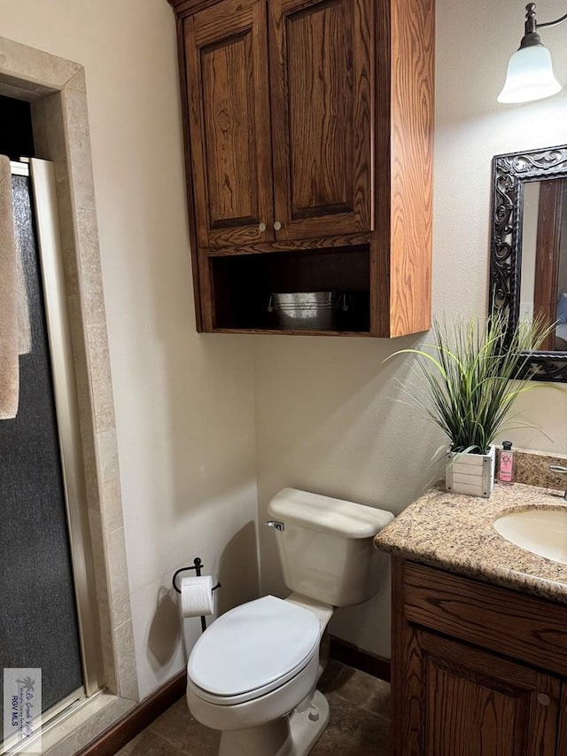 bathroom with tile patterned floors, vanity, and toilet