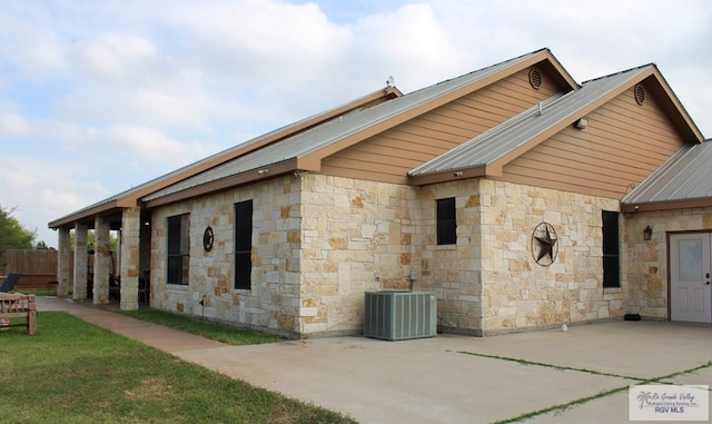 view of home's exterior featuring cooling unit and a patio