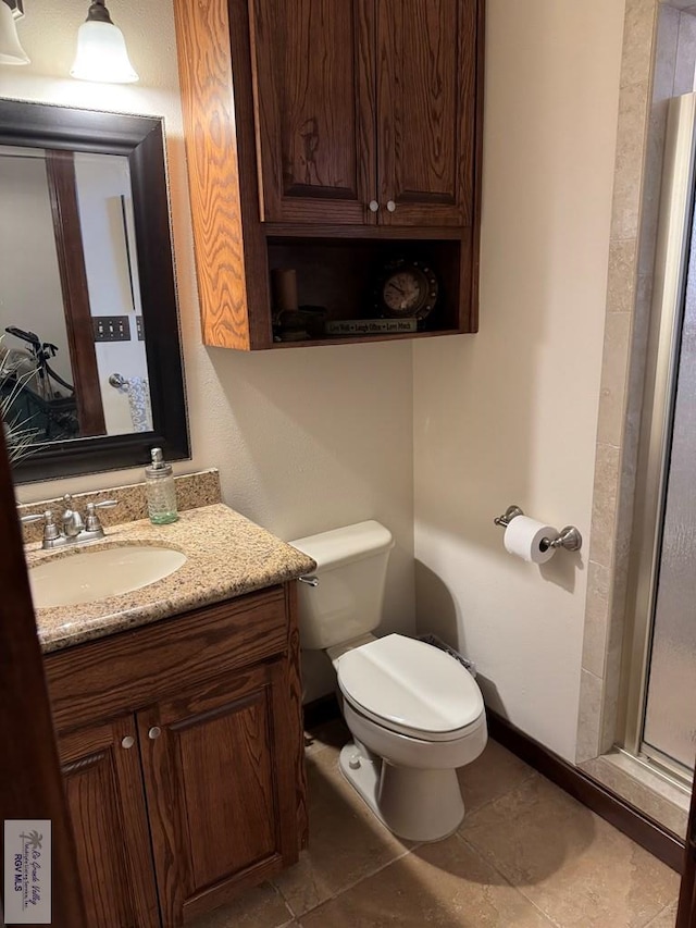 bathroom with vanity, tile patterned flooring, and toilet