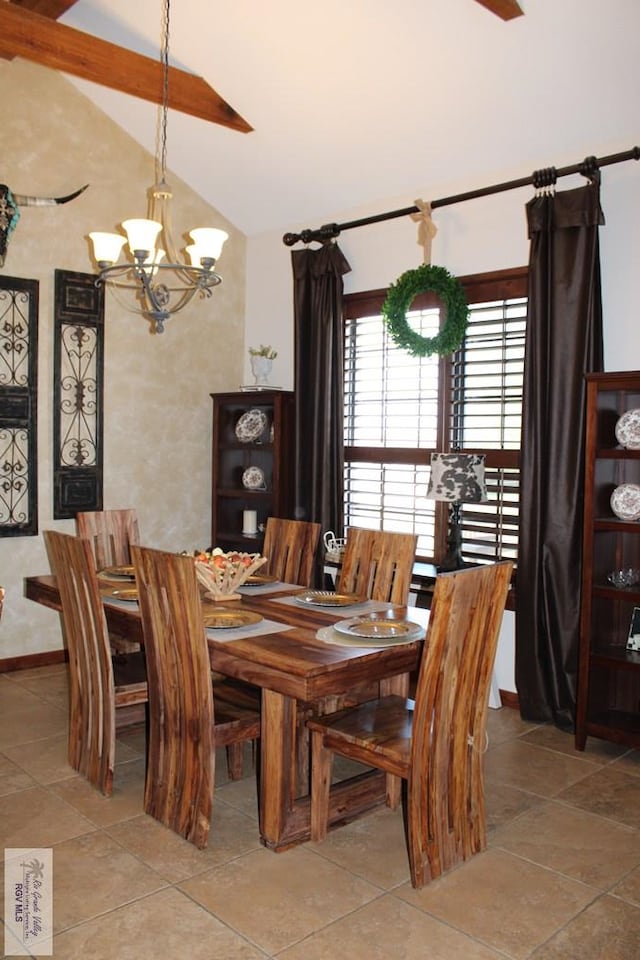 tiled dining space featuring a notable chandelier and high vaulted ceiling