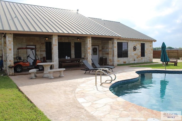 view of pool with an outdoor structure and a patio