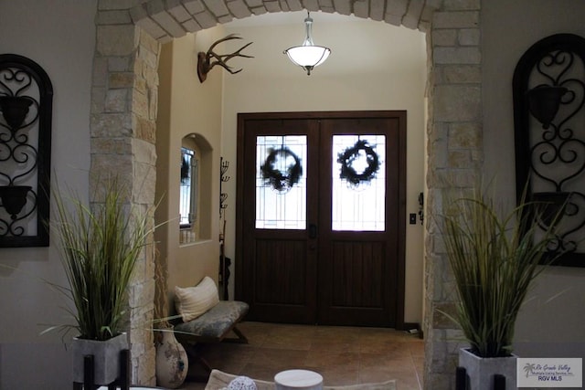 tiled foyer featuring french doors