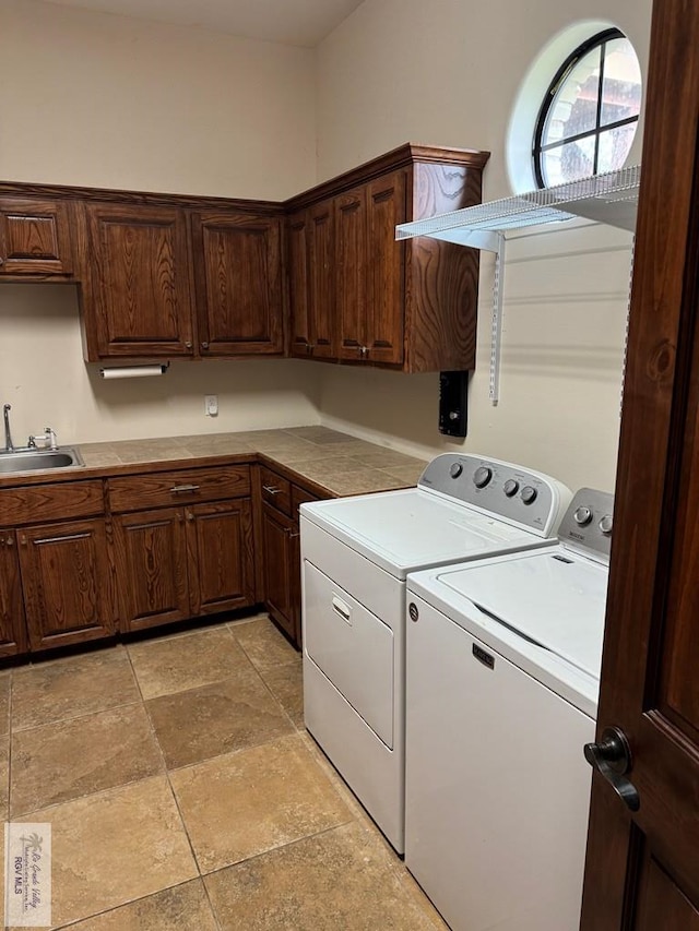 clothes washing area with cabinets, sink, and independent washer and dryer