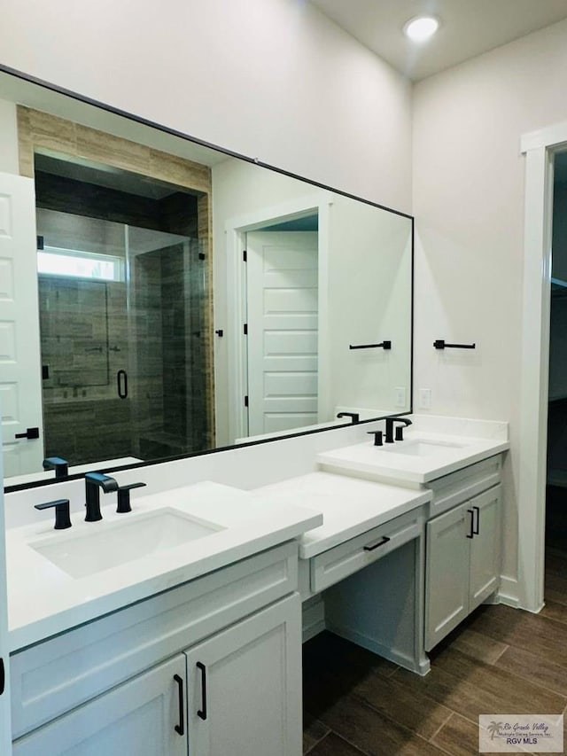 3601 Mattie Ln, Harlingen, TX 78550 - bathroom with double vanity, a stall shower, wood finished floors, and recessed lighting