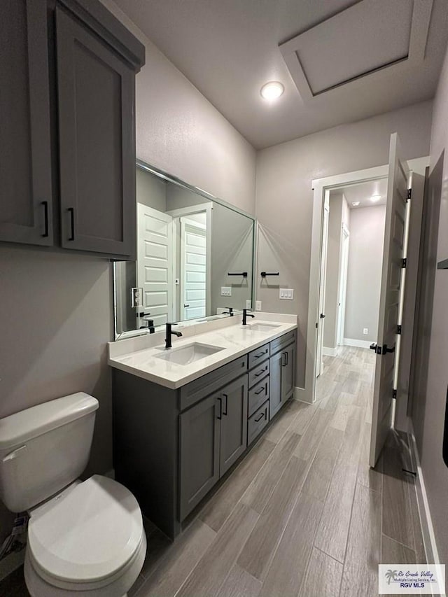 bathroom with vanity, hardwood / wood-style flooring, and toilet