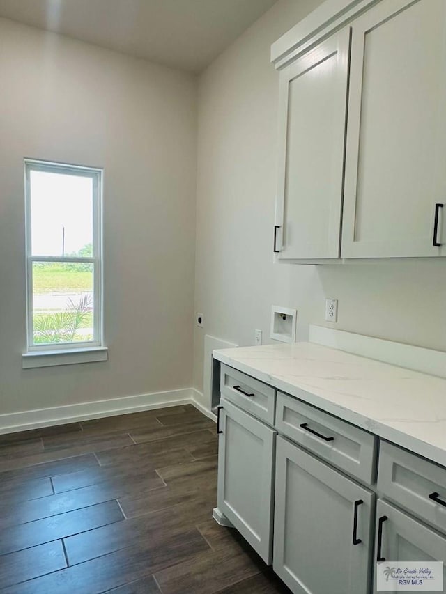 3601 Mattie Ln, Harlingen, TX 78550 - laundry area with dark wood-style floors, hookup for an electric dryer, cabinet space, baseboards, and hookup for a washing machine