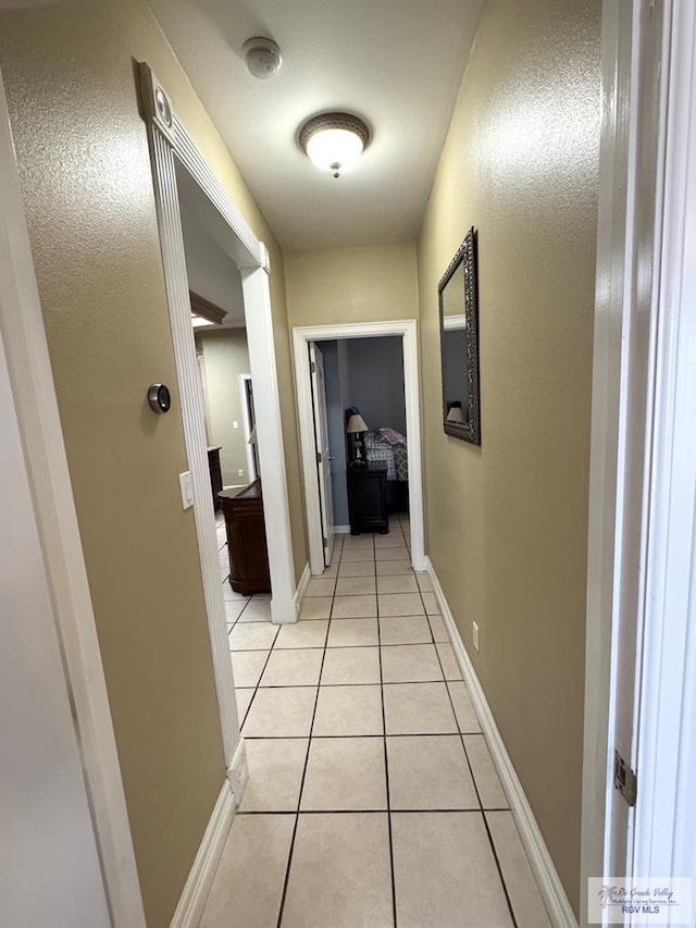 6020 Rusty Nail Dr, Brownsville, TX 78526 - hall with light tile patterned floors and baseboards