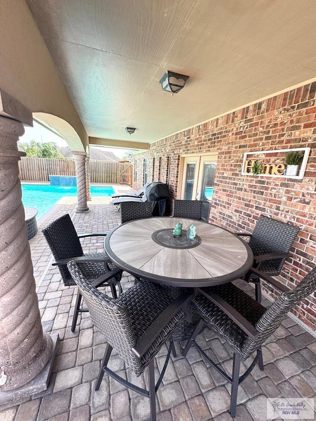 6020 Rusty Nail Dr, Brownsville, TX 78526 - fenced backyard featuring a patio, an outdoor pool, and outdoor dining area