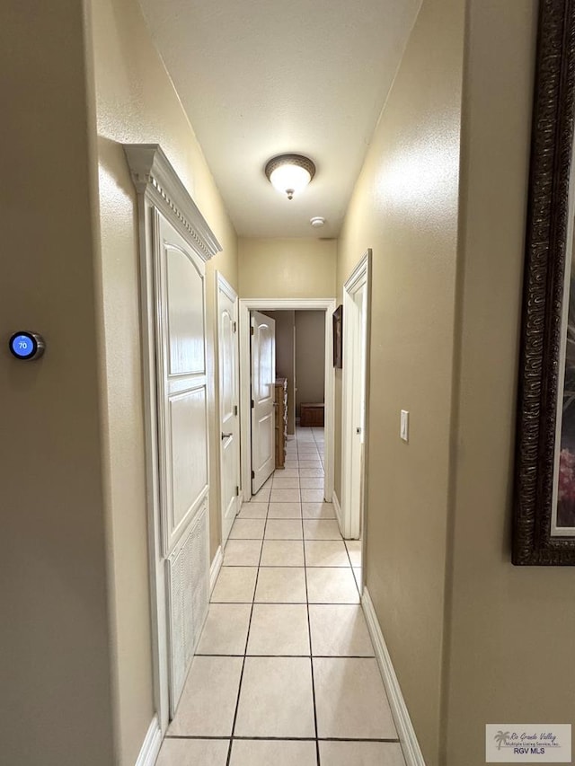 6020 Rusty Nail Dr, Brownsville, TX 78526 - hall with light tile patterned floors and baseboards