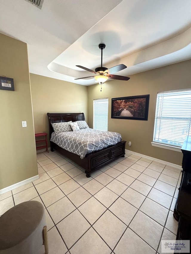 6020 Rusty Nail Dr, Brownsville, TX 78526 - bedroom featuring a tray ceiling, light tile patterned floors, and ceiling fan