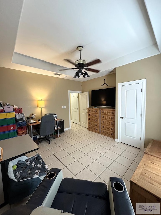 6020 Rusty Nail Dr, Brownsville, TX 78526 - living area featuring light tile patterned floors, a ceiling fan, and a tray ceiling