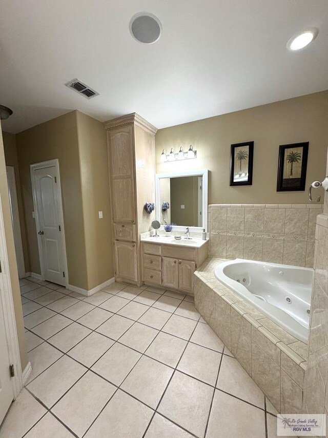 6020 Rusty Nail Dr, Brownsville, TX 78526 - bathroom with a jetted tub, vanity, and tile patterned flooring