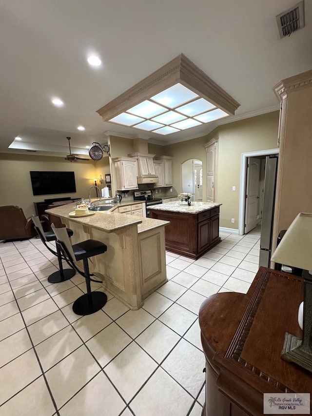 6020 Rusty Nail Dr, Brownsville, TX 78526 - kitchen with a peninsula, light tile patterned floors, open floor plan, arched walkways, and refrigerator