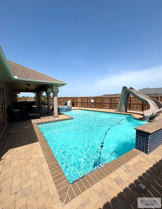 6020 Rusty Nail Dr, Brownsville, TX 78526 - view of pool featuring a water slide, a patio area, and a fenced backyard