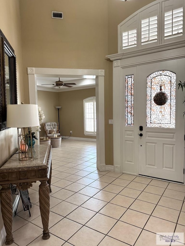 6020 Rusty Nail Dr, Brownsville, TX 78526 - foyer entrance with a high ceiling, light tile patterned floors, a ceiling fan, and ornamental molding