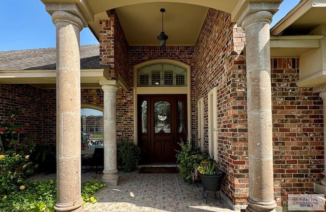 6020 Rusty Nail Dr, Brownsville, TX 78526 - property entrance with brick siding and a shingled roof