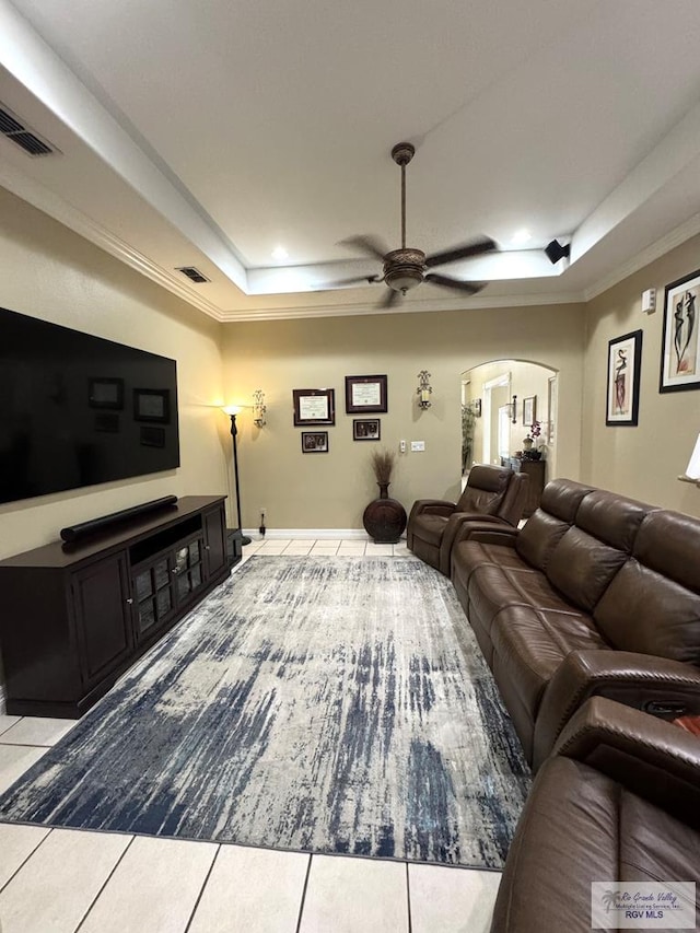 6020 Rusty Nail Dr, Brownsville, TX 78526 - living area with a tray ceiling, arched walkways, tile patterned flooring, ceiling fan, and crown molding