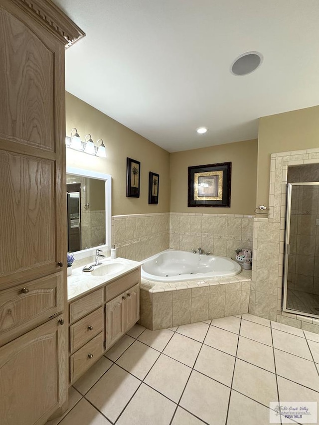 6020 Rusty Nail Dr, Brownsville, TX 78526 - full bathroom featuring tile patterned floors, a whirlpool tub, vanity, a stall shower, and a wainscoted wall