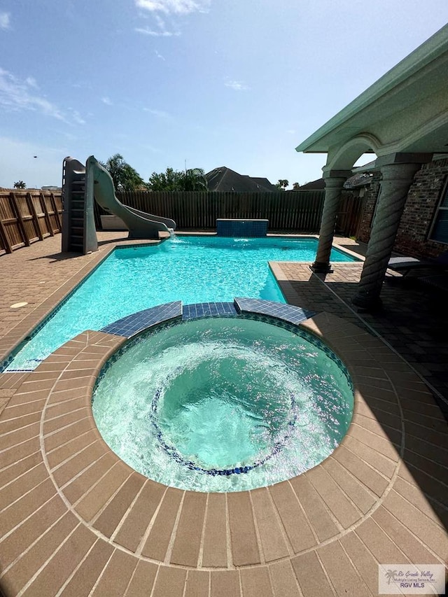 6020 Rusty Nail Dr, Brownsville, TX 78526 - view of swimming pool with a water slide and a pool with connected hot tub