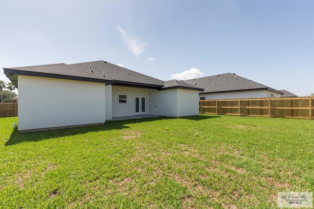 rear view of property featuring a yard and french doors