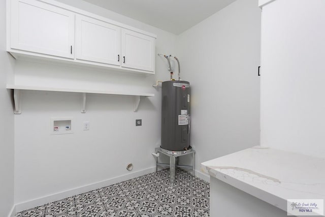 clothes washing area featuring hookup for an electric dryer, hookup for a washing machine, electric water heater, and cabinets