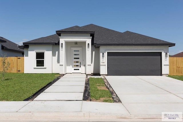 prairie-style house featuring a garage and a front yard