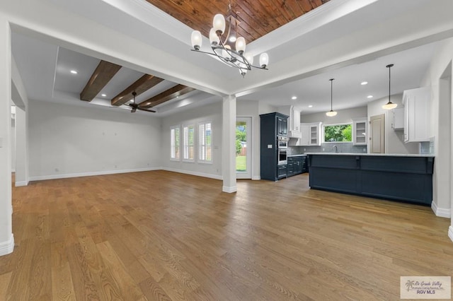 8005 King Sago Ct, Harlingen, TX 78552 - unfurnished living room featuring a chandelier, light wood-type flooring, recessed lighting, a wood ceiling with exposed beams, and ceiling fan