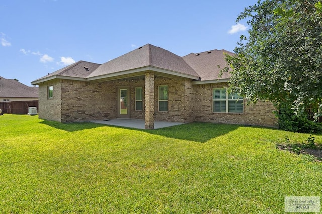 8005 King Sago Ct, Harlingen, TX 78552 - rear view of house with brick siding, a patio area, and a yard