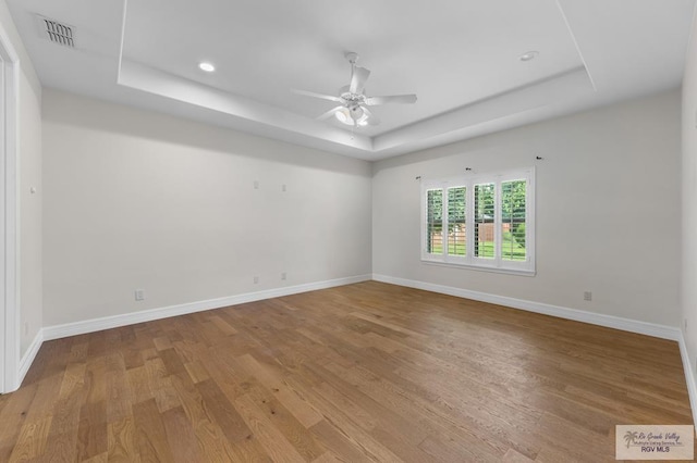 8005 King Sago Ct, Harlingen, TX 78552 - unfurnished room featuring a raised ceiling, ceiling fan, wood finished floors, and recessed lighting