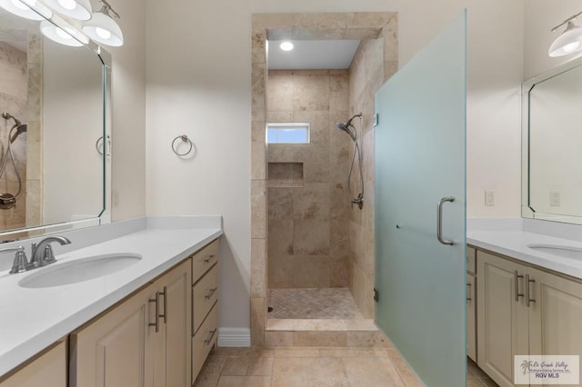8005 King Sago Ct, Harlingen, TX 78552 - bathroom featuring a stall shower and two vanities