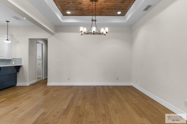 8005 King Sago Ct, Harlingen, TX 78552 - unfurnished dining area featuring a tray ceiling, wooden ceiling, light wood-type flooring, a chandelier, and recessed lighting
