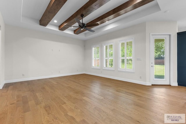8005 King Sago Ct, Harlingen, TX 78552 - empty room featuring beam ceiling, a ceiling fan, light wood-style floors, and a raised ceiling