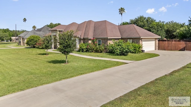 8005 King Sago Ct, Harlingen, TX 78552 - view of front of home featuring driveway, an attached garage, and brick siding