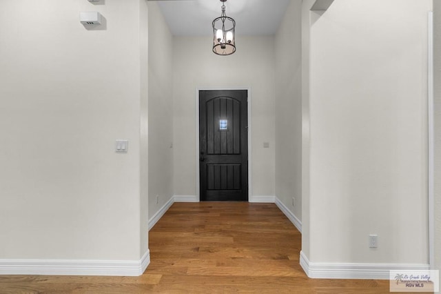 8005 King Sago Ct, Harlingen, TX 78552 - foyer with light wood-style flooring and a chandelier