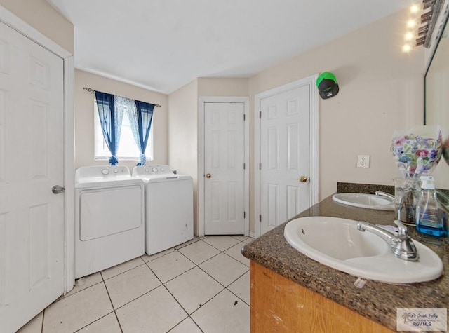 6540 Dockberry Rd, Brownsville, TX 78521 - bathroom featuring washing machine and dryer, double vanity, and tile patterned floors