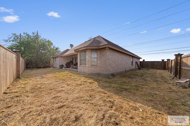 6540 Dockberry Rd, Brownsville, TX 78521 - back of house featuring brick siding and a fenced backyard
