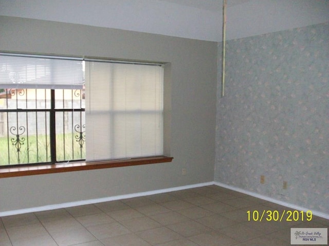 unfurnished room featuring tile patterned flooring