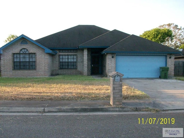 ranch-style house with a garage and a front yard